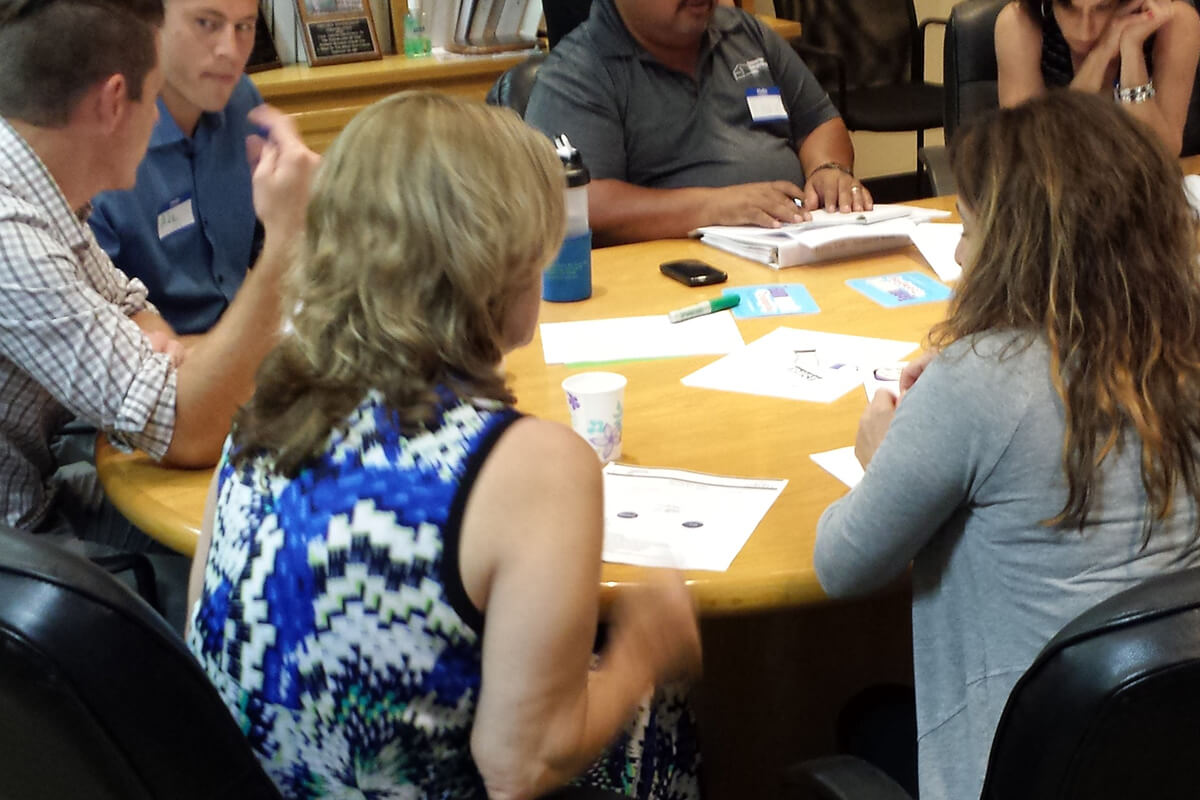 Office team meeting at conference room table.